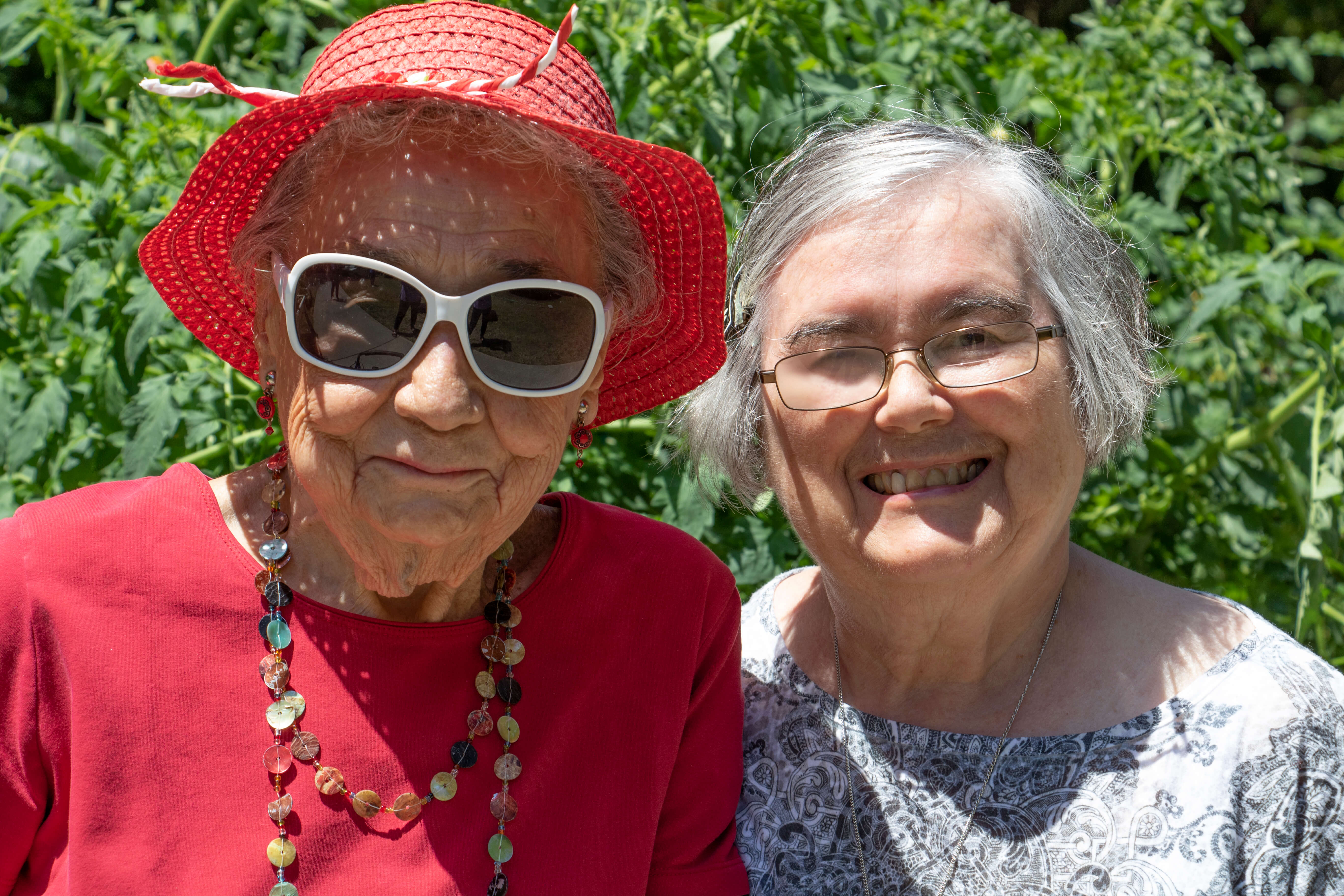 two woman and flowers residents group outside sunglasses